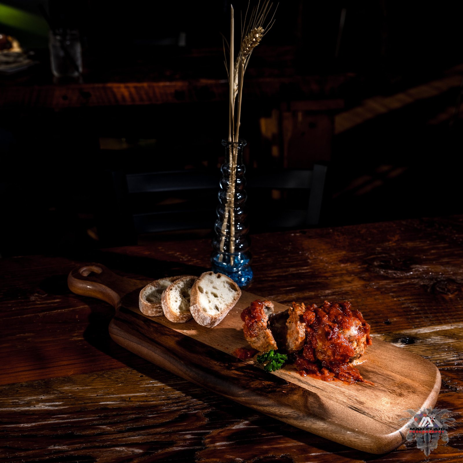 Food photography, a bread and meat ball sample appetizer plate on cutting board.