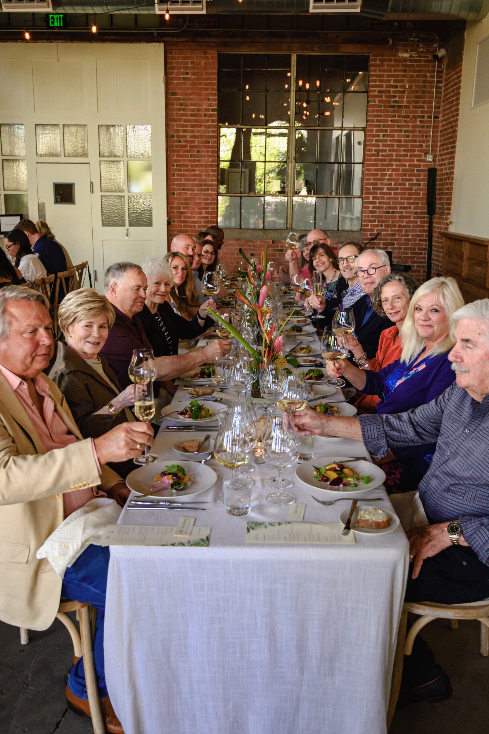 Event dinner with people cheering drinks.
